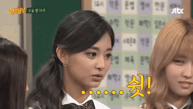 a group of girls are standing in front of a sign that says ' jtbc ' on it