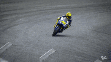 a man riding a motorcycle with the number 46 on his helmet