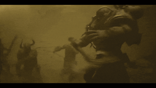 a silhouette of a man with horns standing in a foggy room