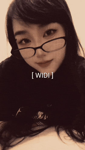 a woman wearing glasses has the word widi on the bottom right