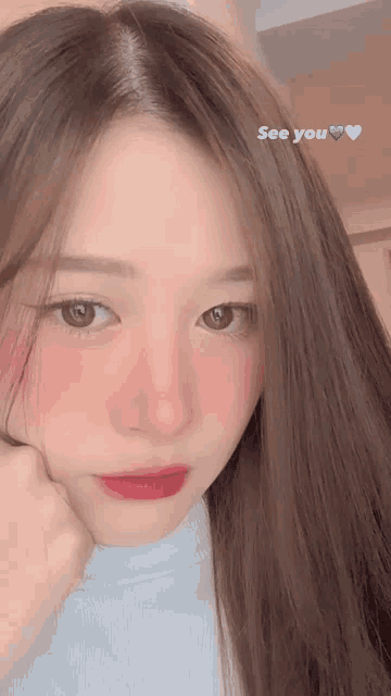 a close up of a woman 's face with the words " see you " written below her