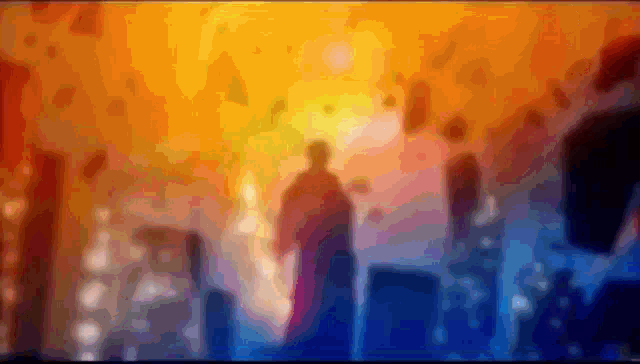 a blurry picture of a person standing in front of a sunset