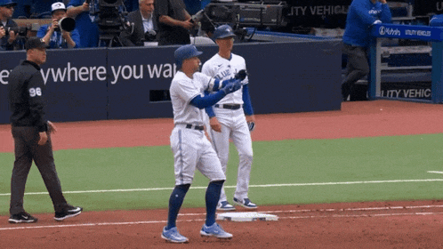 baseball players on a field with a sign that says where you walk