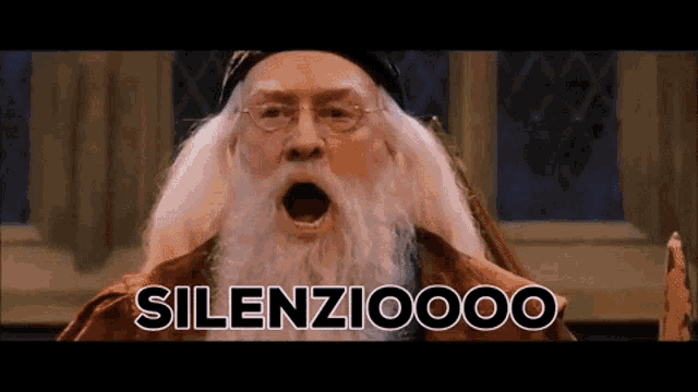a man with a beard and glasses says silenziooo with his mouth open