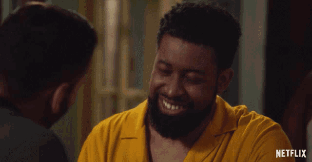 a man in a yellow shirt has a netflix logo on the bottom