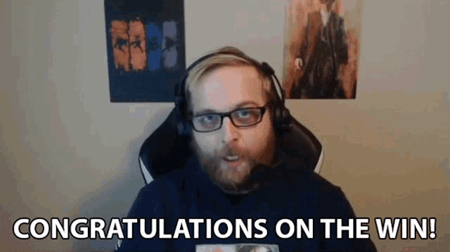 a man wearing glasses and headphones is congratulating on the win