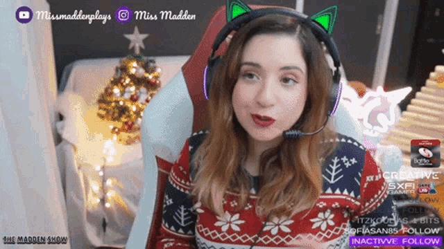 a woman wearing a cat ear headset with miss madden written on it