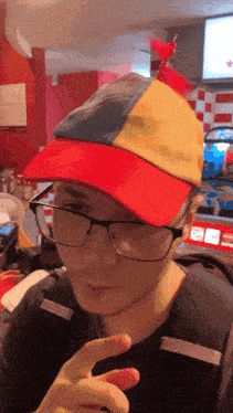 a man wearing glasses and a hat with a flag on top