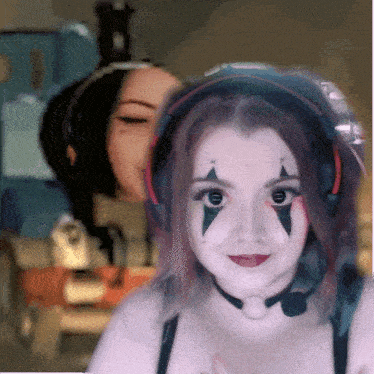 a woman with makeup on her face and headphones