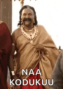 a man in a costume with a mustache and a necklace is standing next to a woman .