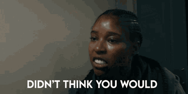 a woman says " didn 't think you would " in front of a wall