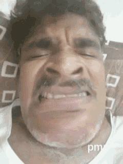 a man with a mustache is making a funny face and the word pm is on the bottom
