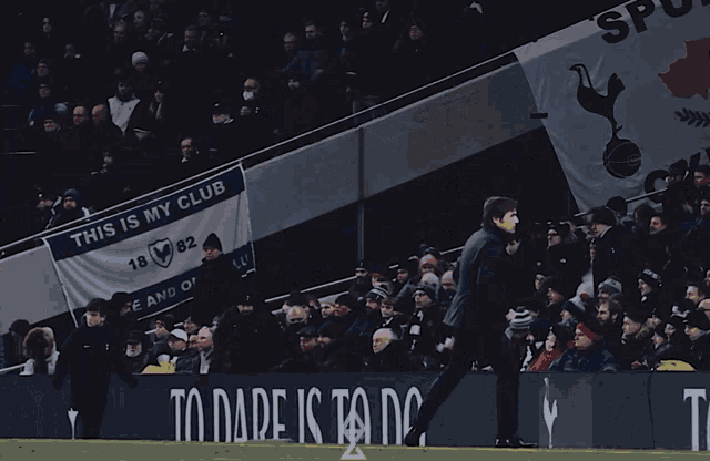 a banner that says this is my club hangs above a crowd