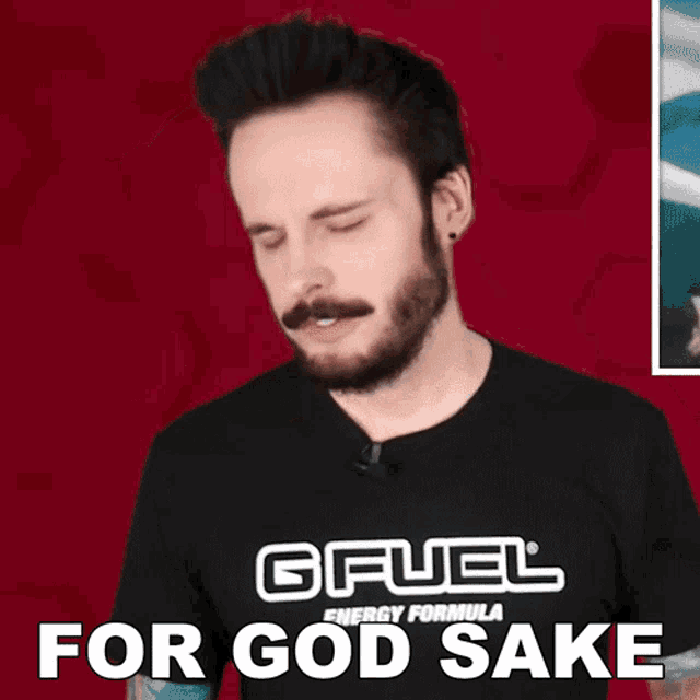 a man wearing a black gfuel energy formula shirt wipes his nose