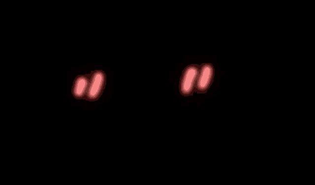 a pink heart is glowing on a black background