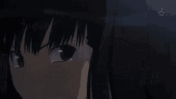 a close up of a girl 's face with a glowing eye in the dark .