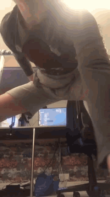 a man is standing in front of a computer screen that says 7:25