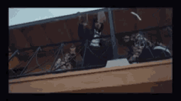 a group of people are sitting on a balcony .
