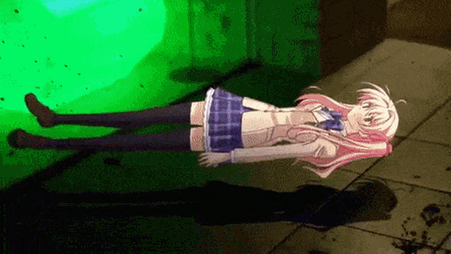 a girl in a school uniform is laying on the ground