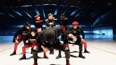 a group of men are dancing and one of them has a shirt that says ' a.d ' on it