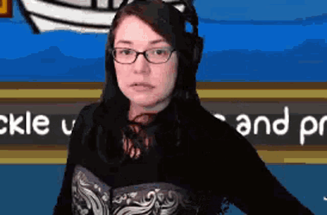 a woman wearing glasses and headphones is standing in front of a sign that says and