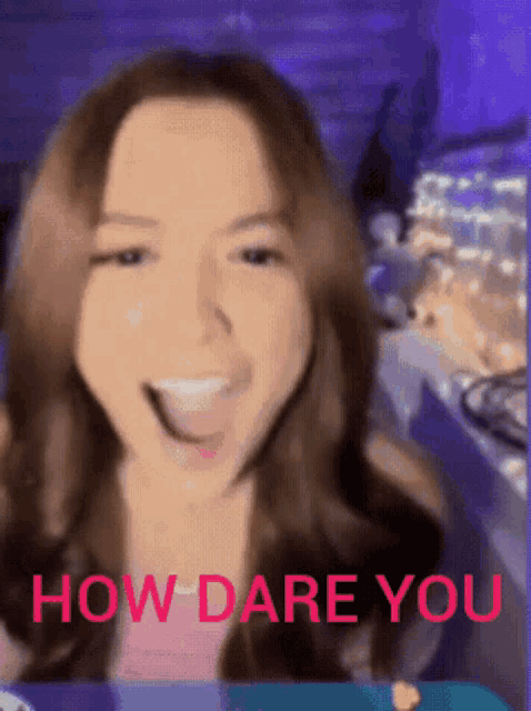 a woman is smiling with the words " how dare you " written in red