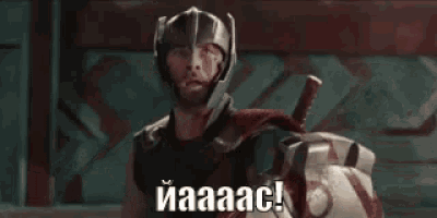 thor is wearing a helmet and holding a shield while standing next to a giant robot .