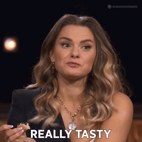 a woman holding a piece of food with the word really tasty below her