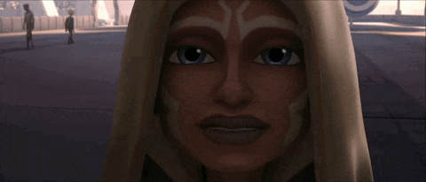 a close up of a woman 's face with a hood on her head .