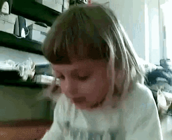 a little girl wearing a shirt that says ' i love you '