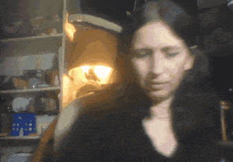 a blurry picture of a woman 's face with a light shining on her face