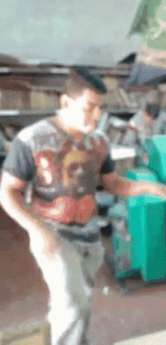 a blurry picture of a man wearing a shirt that says ' avengers '