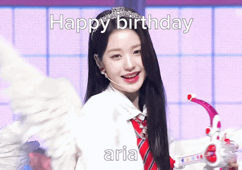 a girl with angel wings is holding a gun with the words happy birthday aria written on it