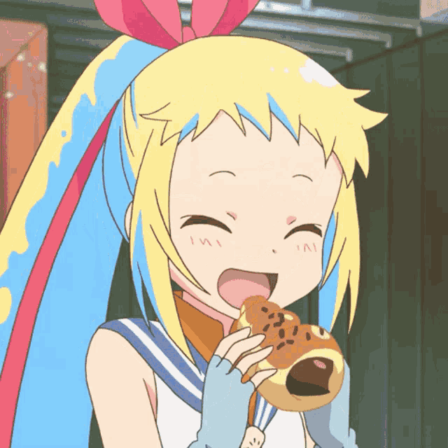 a girl with a bow in her hair is eating a doughnut