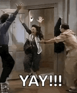 a group of people are jumping in the air in a room with the words `` yay !!! '' written on the bottom .