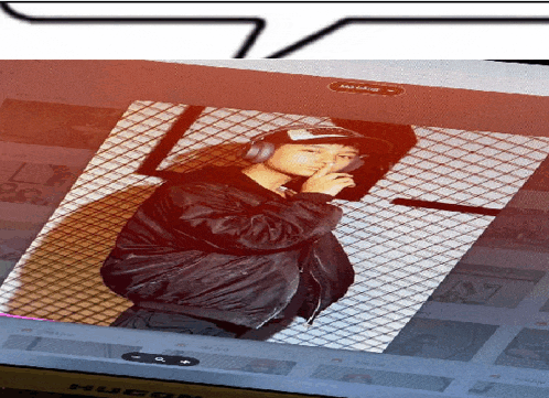 a picture of a man wearing headphones and a hat is displayed on a computer screen