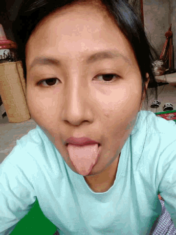 a girl sticking her tongue out in a selfie