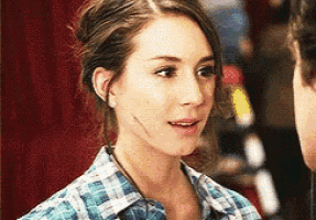 a woman in a plaid shirt has a scar on her face