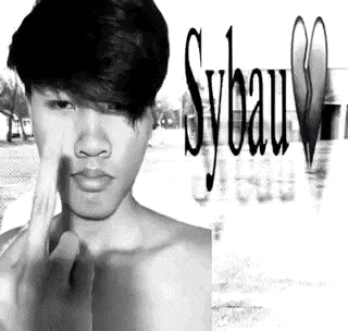 a black and white photo of a shirtless man making a funny face with his finger on his nose .