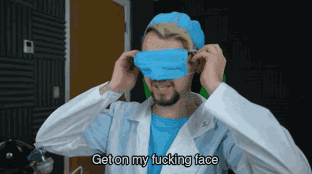 a man in a lab coat is putting on a blue mask and says " get on my fucking face "