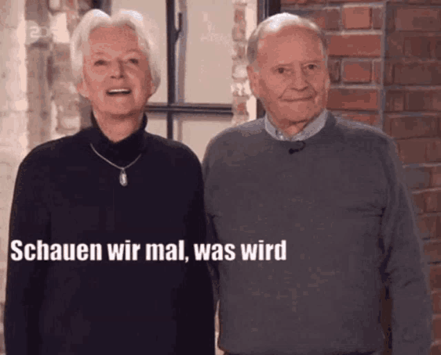 a man and a woman are standing next to each other with the words schauen wir mal was wird written on the bottom