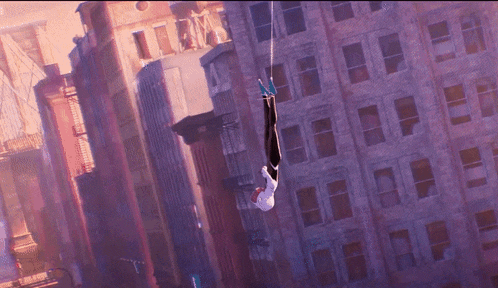 two spidermans are hanging from a rope in the air