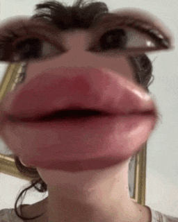 a close up of a woman making a funny face with her mouth open .