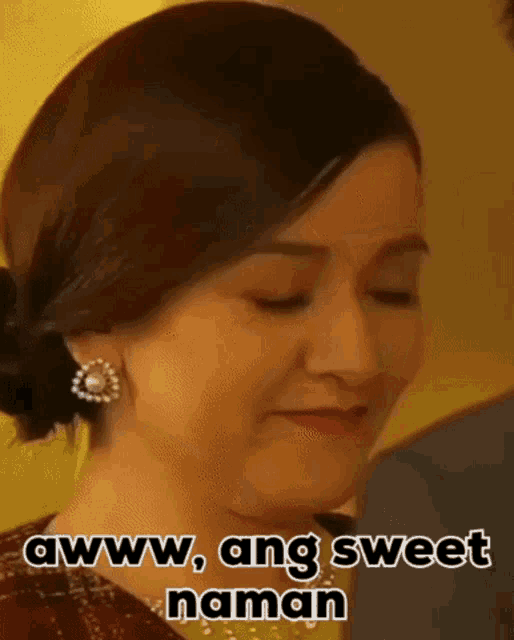 a close up of a woman 's face with the words awww , ang sweet naman written on it