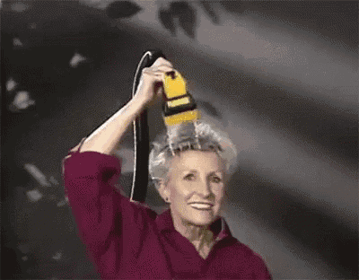 a woman in a red shirt is holding a hose over her head