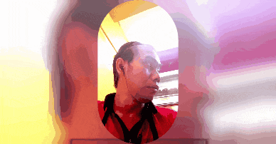a pixelated image of a man in a red shirt with headphones