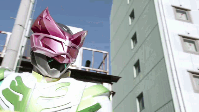 a superhero is standing in front of a building wearing a pink mask