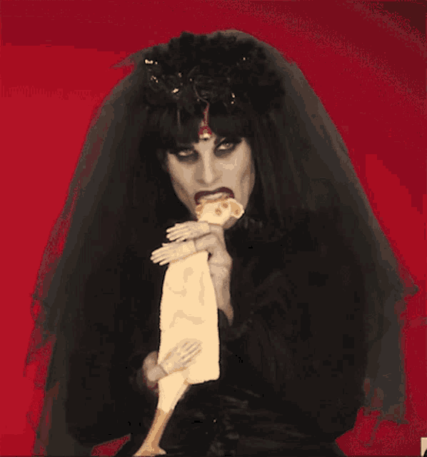 a woman in a veil is eating a piece of pizza