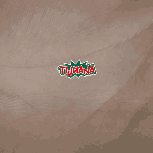 a logo for tijuana is displayed on a brown surface