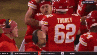 a football player with the number 62 on his jersey is surrounded by other players